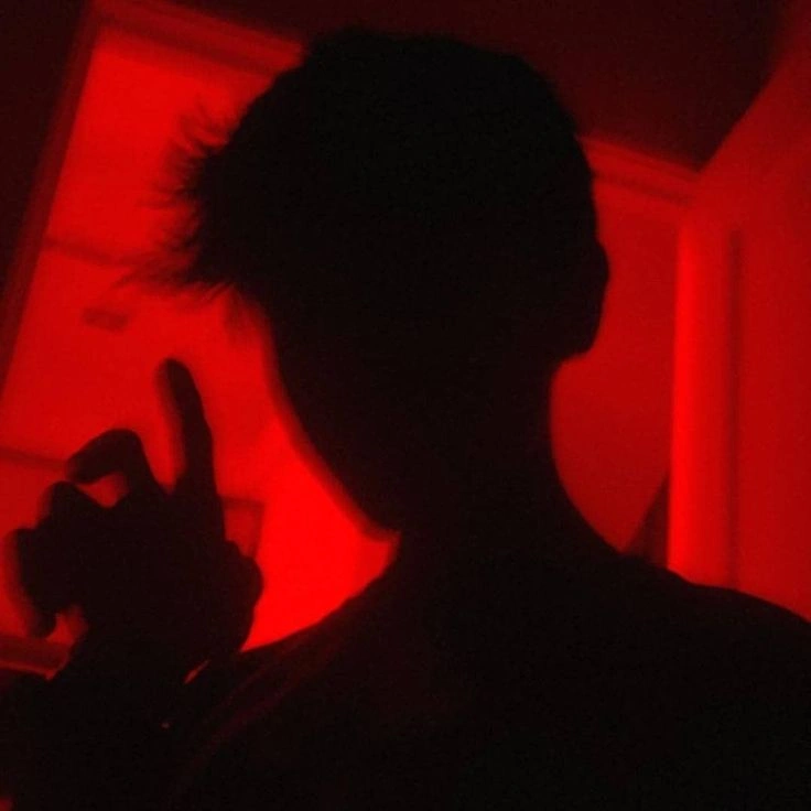 Boy red PFP aesthetic with dark shadow contrast and neon crimson glow
