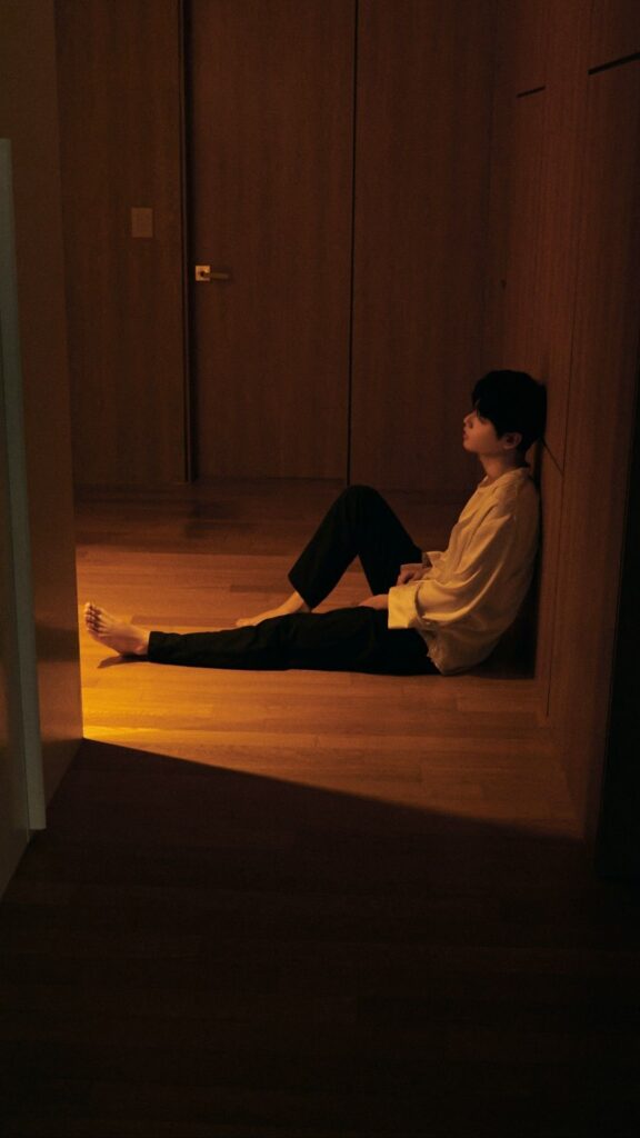 Boy sad PFP aesthetic with low saturation color and downward contemplative gaze