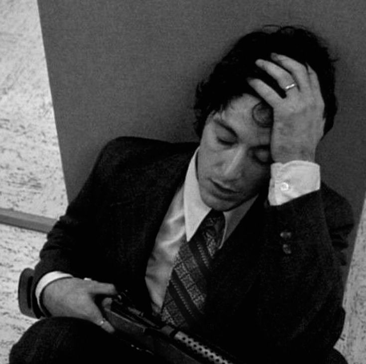 Sad Scarface PFP with low lighting and distant melancholic expression