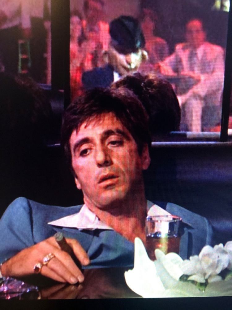 Melancholic Scarface profile picture with muted colors and reflective atmosphere
