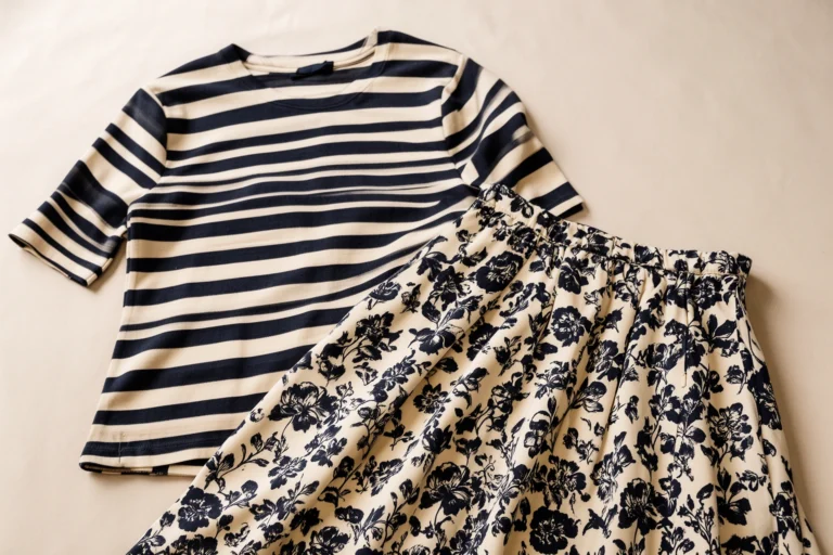 Outfit mixing striped top with floral skirt in coordinated color palette