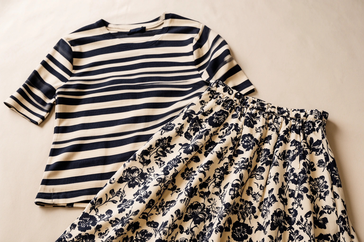 Outfit mixing striped top with floral skirt in coordinated color palette
